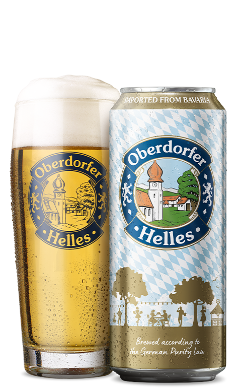 A glass of beer next to a can labeled with Bavarian scenery, both filled with golden beer.